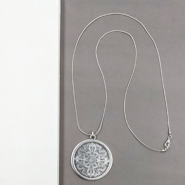 Plain delicate filagree style disc on long snake chain