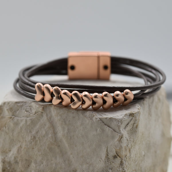 Multi cord leather bracelet with row of small heart beads