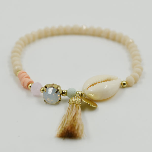 Stretchy boho bracelet with tassel and cowrie shell