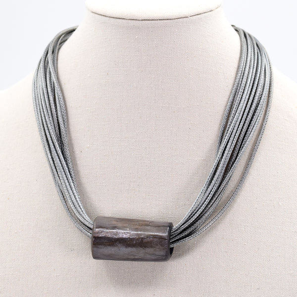 Multi silk cord necklace with tube feature and leather finish back