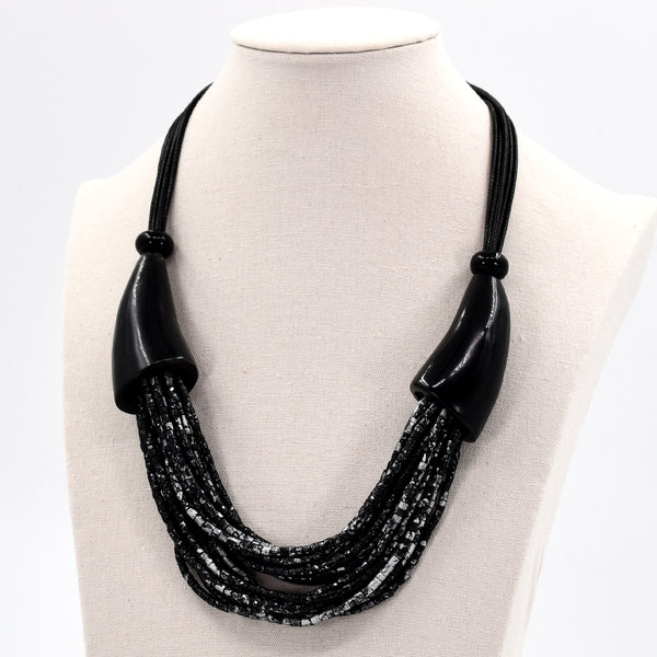 Short statement necklace with multi strand shell section with horn
