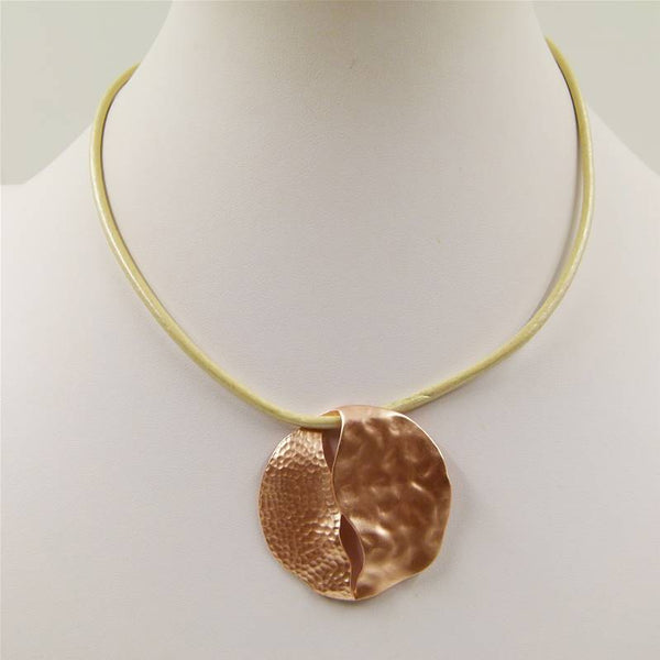 Textured circle pendant with cutout detail on short leather
