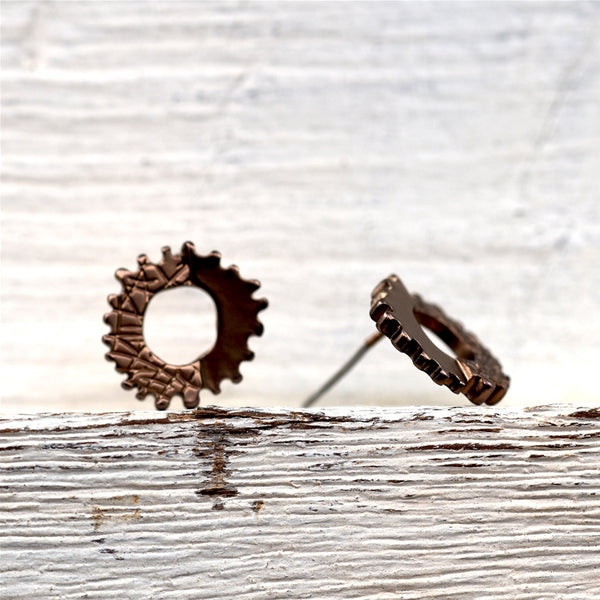 Litle cog style stud earrings in mix texture finish