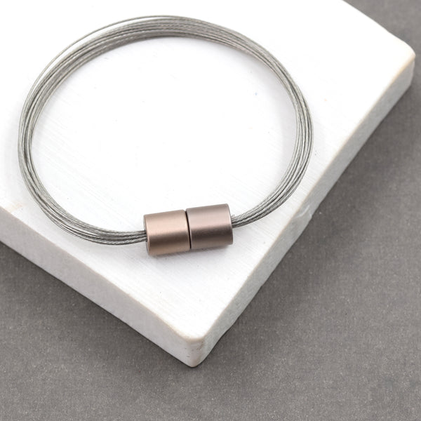 Multi wire contemporary bracelet with cylindrical magnetic